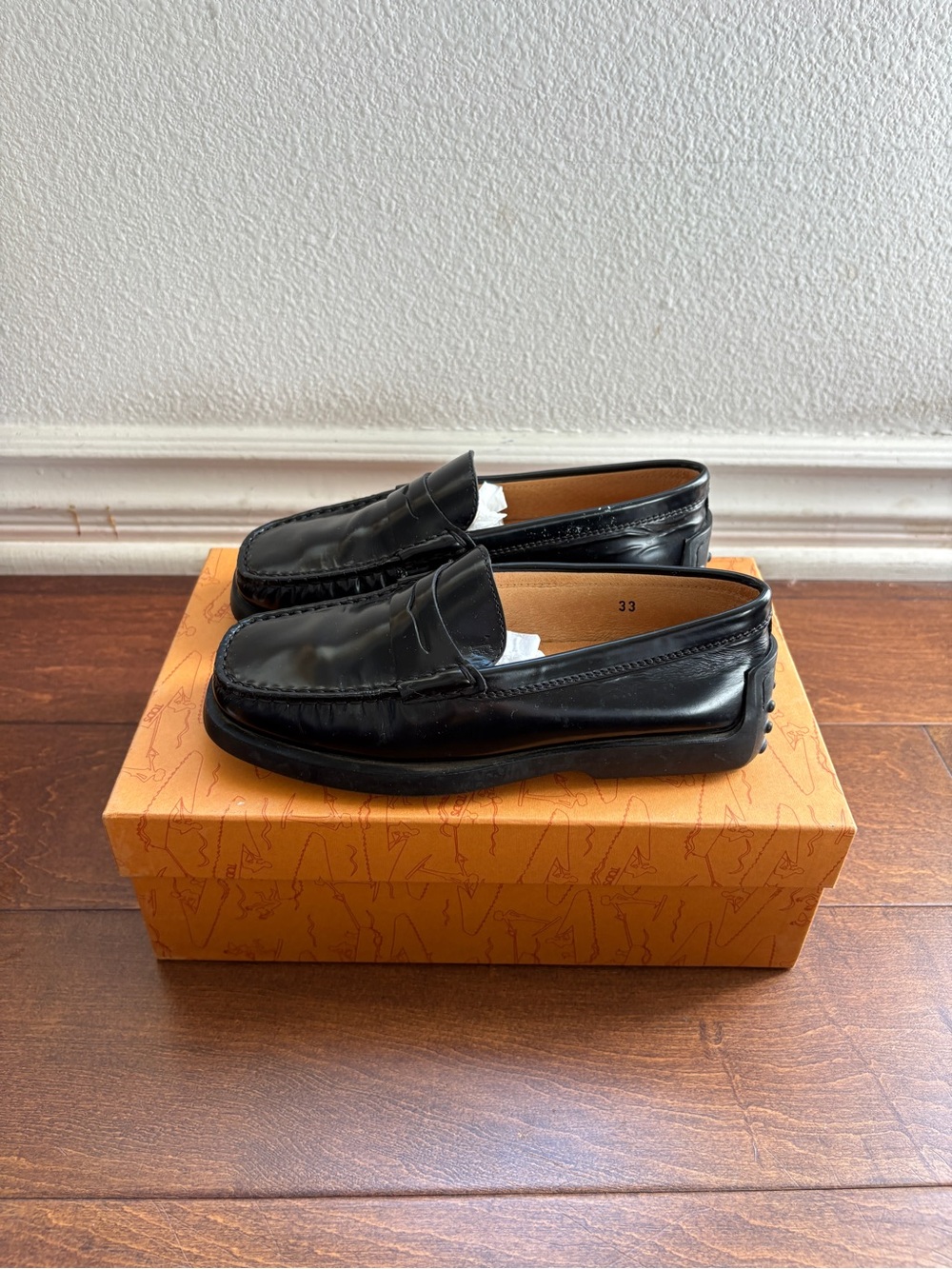 Tod's black patent leather penny loafers